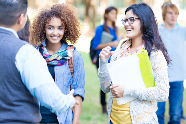 College students talking together outdoors on campus